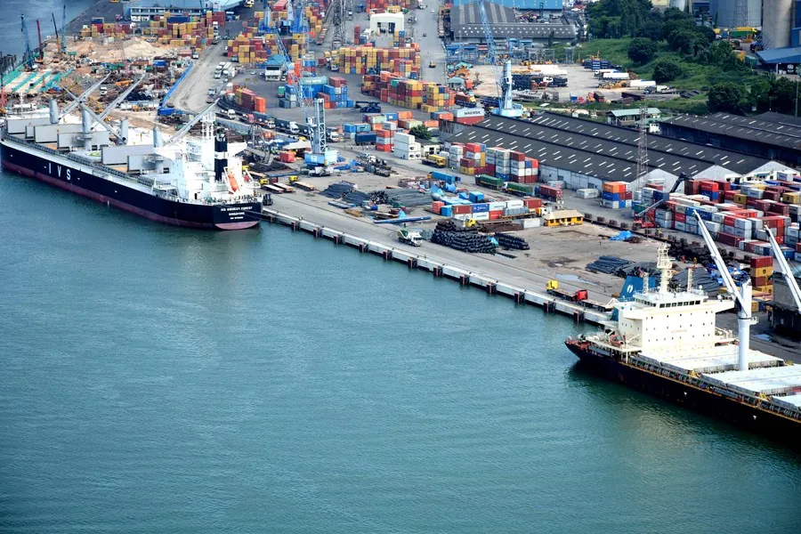 Aerial view of a port with vessels alongside the quay and container stacks
